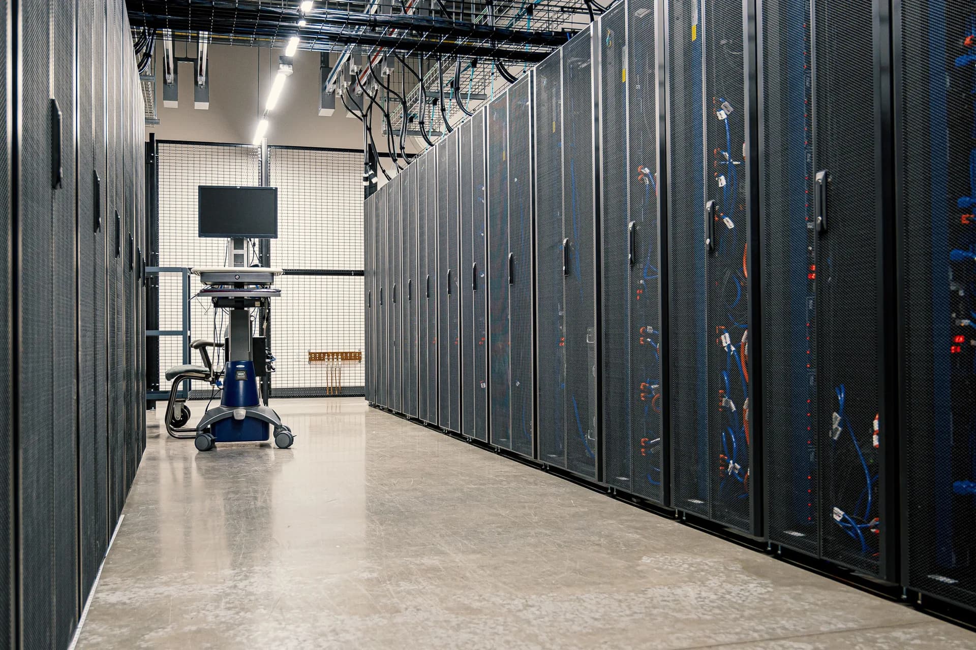 Wide aisle of enterprise server racks in a data center