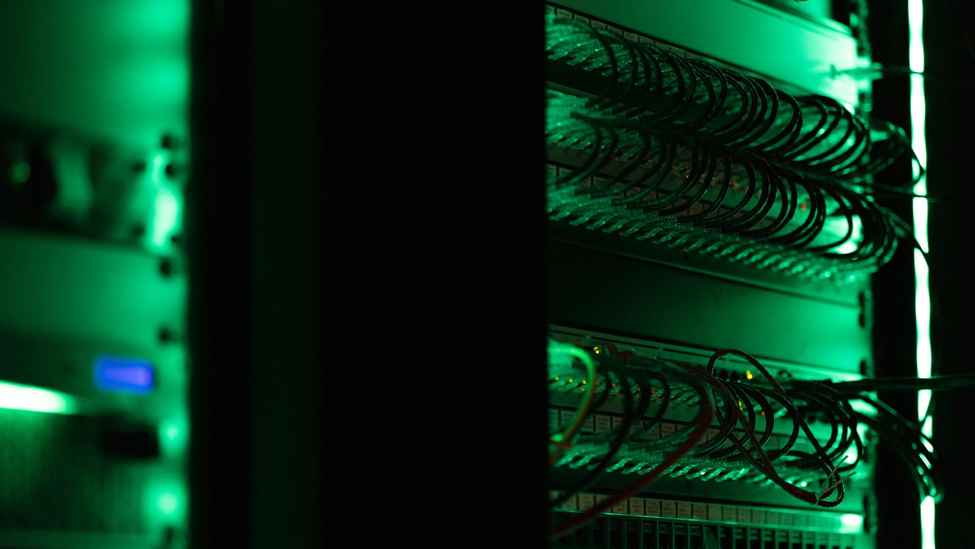 Rear of a server rack with cabling and status lights