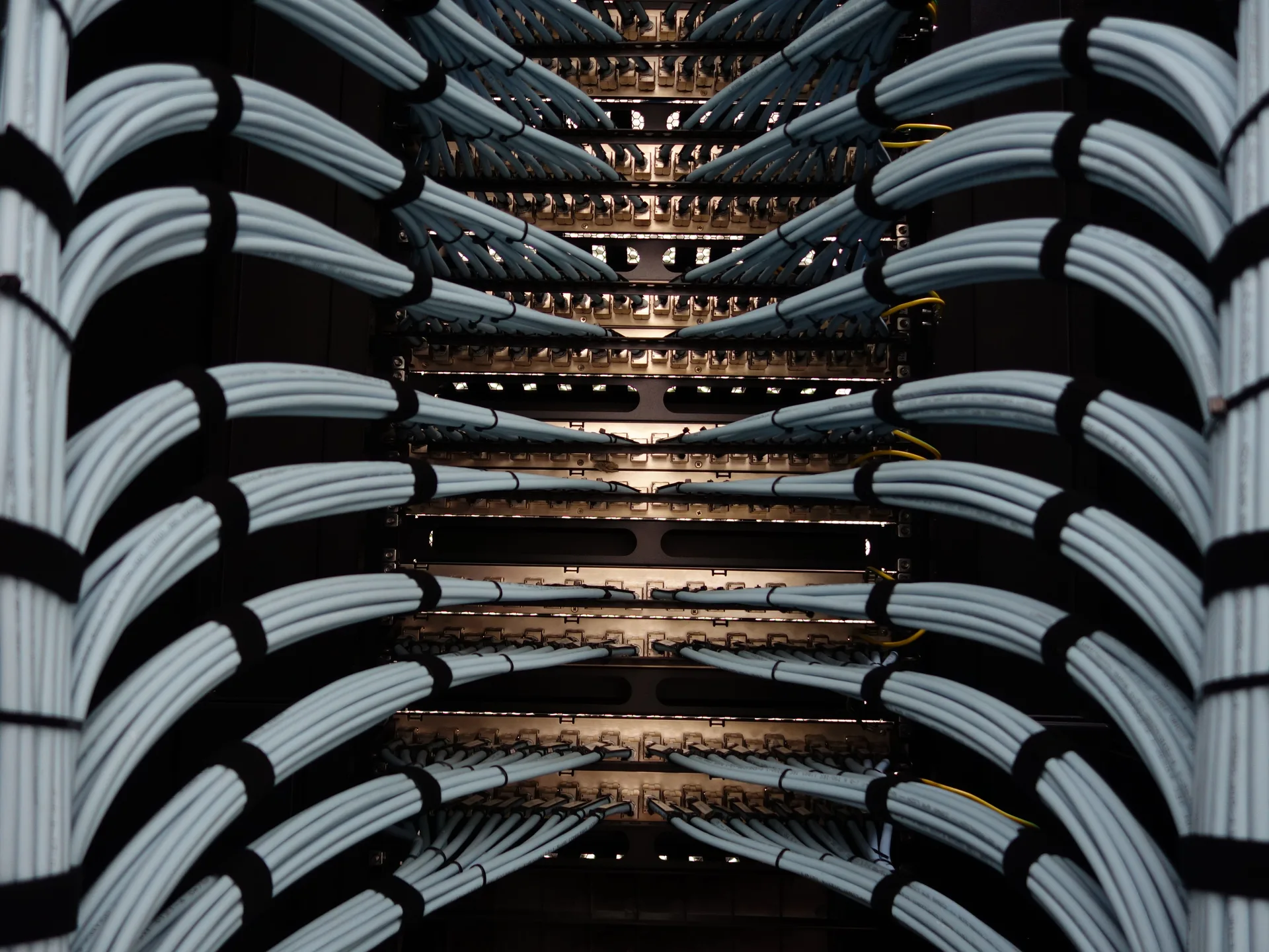Bundled network patch cables routed through a rack