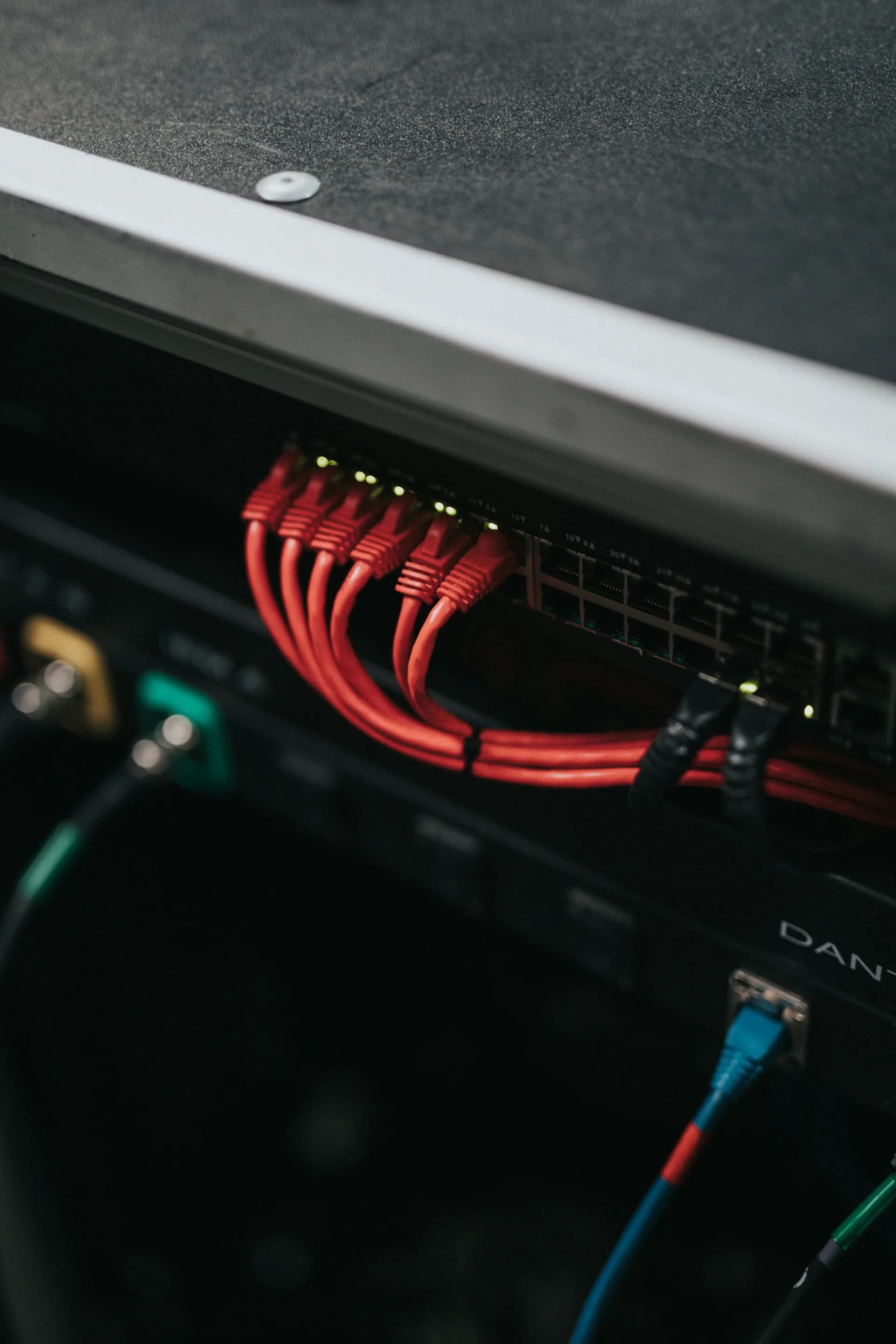 Red patch cables connected to a network switch panel